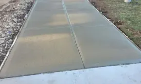 Sidewalk installation replacing cracked and uneven concrete walkway