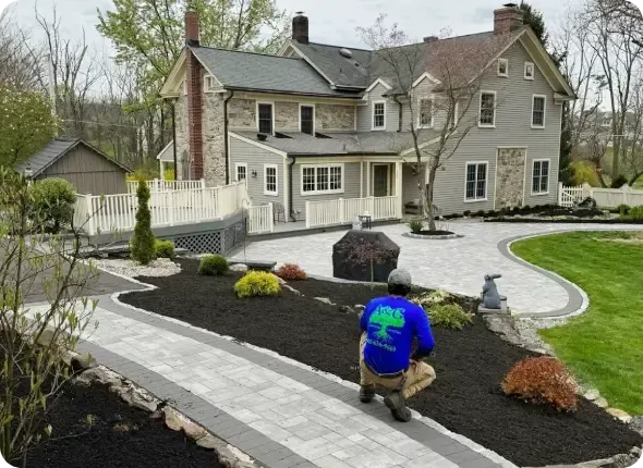 Landscaper walking through residential property evaluating yard conditions and layout