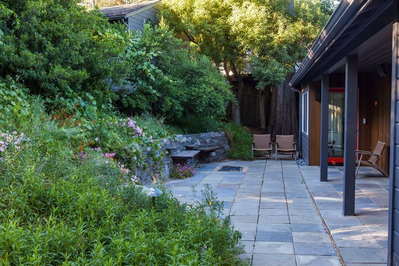 There is a patio with a fire pit in the middle of it.