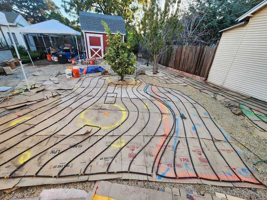 A labyrinth is being built in the backyard of a house.