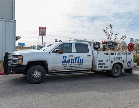 Silver Santin Mobile Repair Unit truck parked on asphalt.