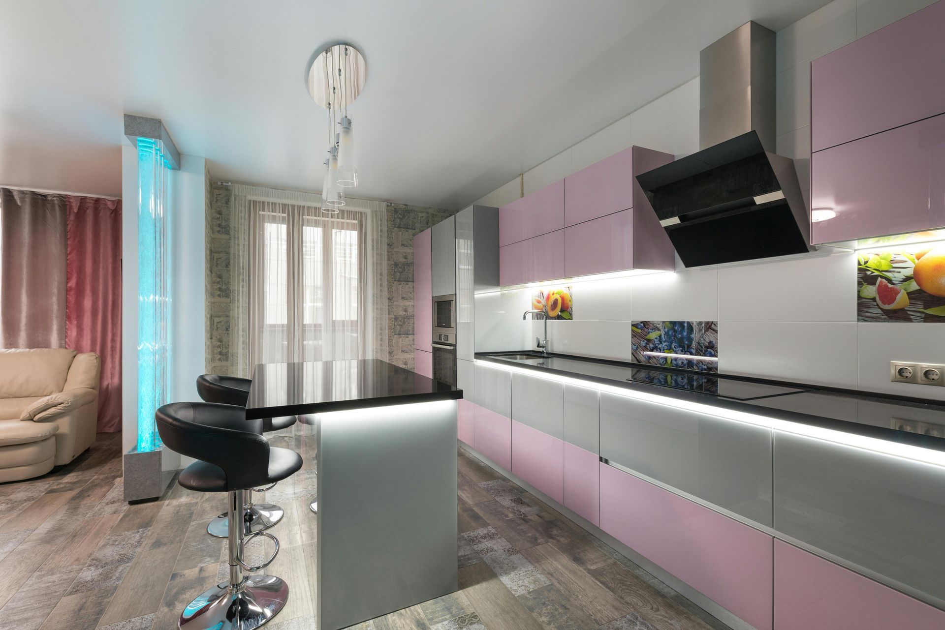 Modern pink-and-black kitchen with island, bar stools, and large windows with curtains