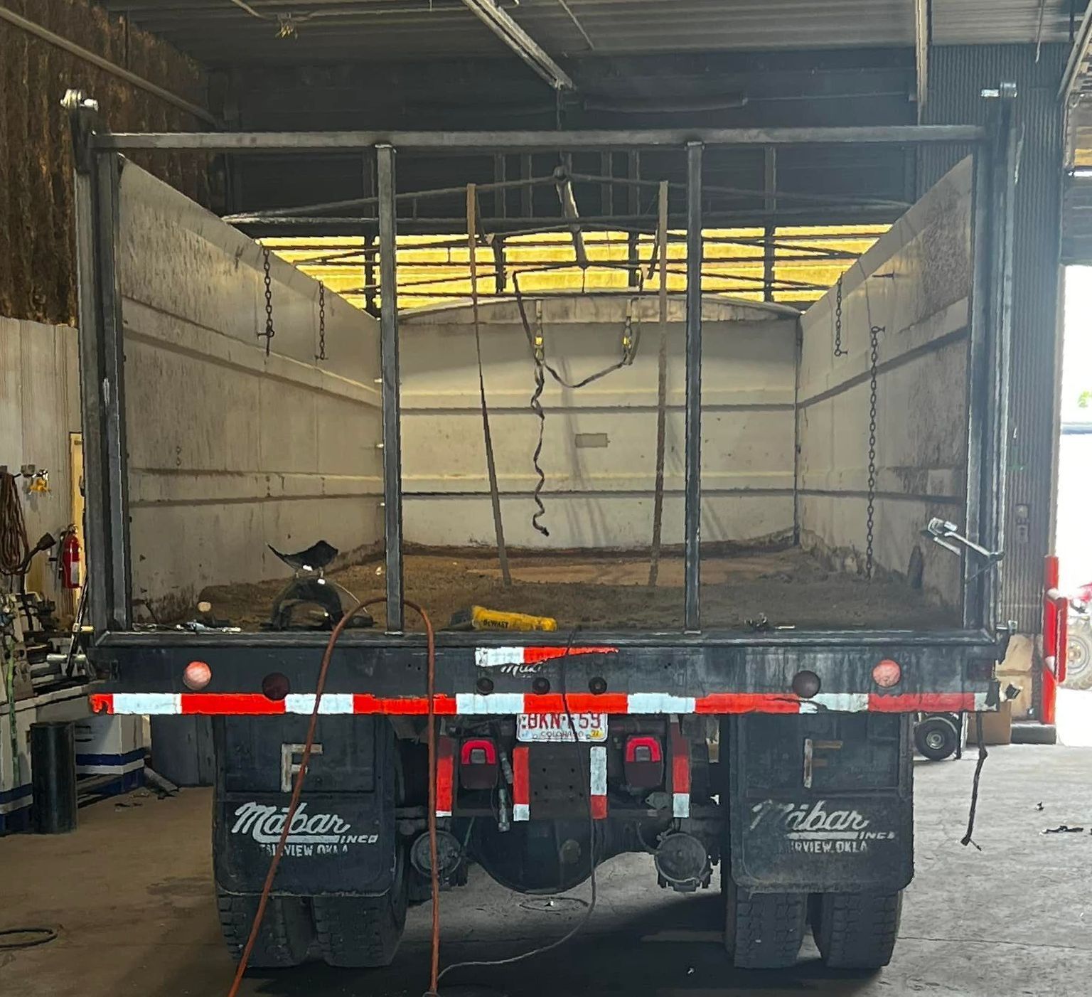 A miller truck is parked in a garage