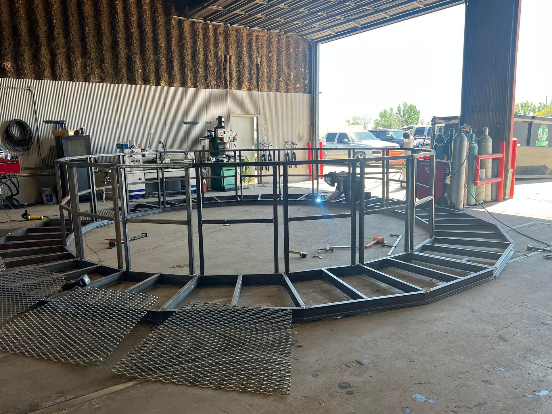 A large metal structure is being built in a garage