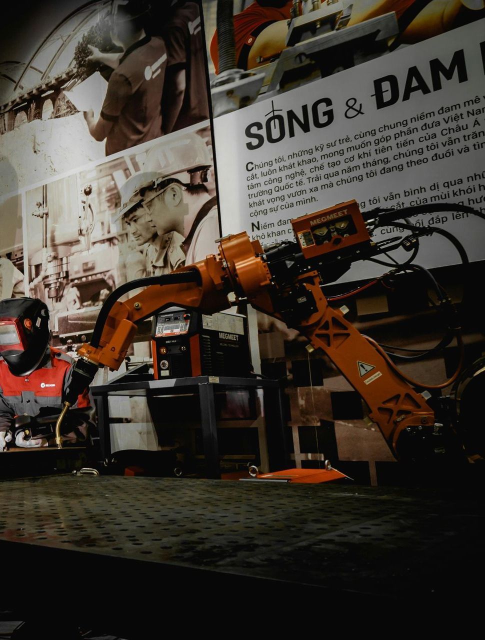 A robotic arm is sitting in front of a sign that says song & dam