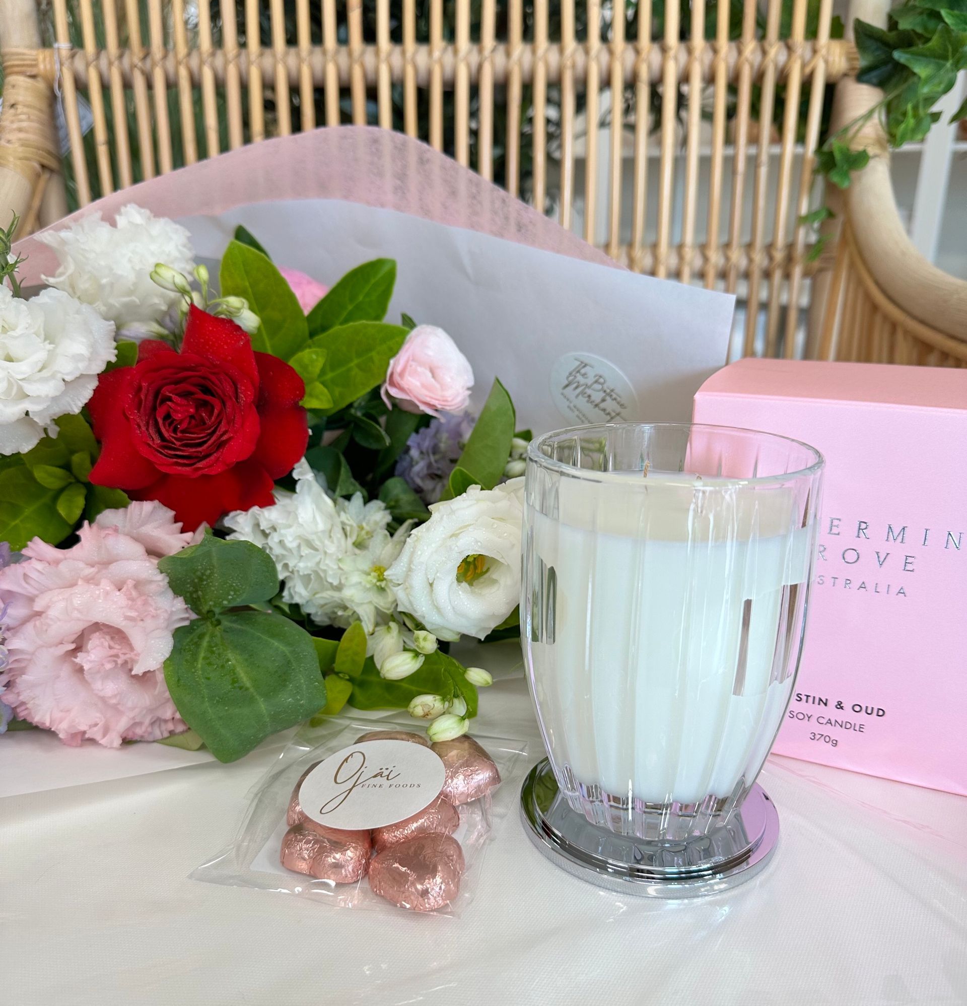  A glass of fresh milk placed beside a vibrant bouquet of flowers.