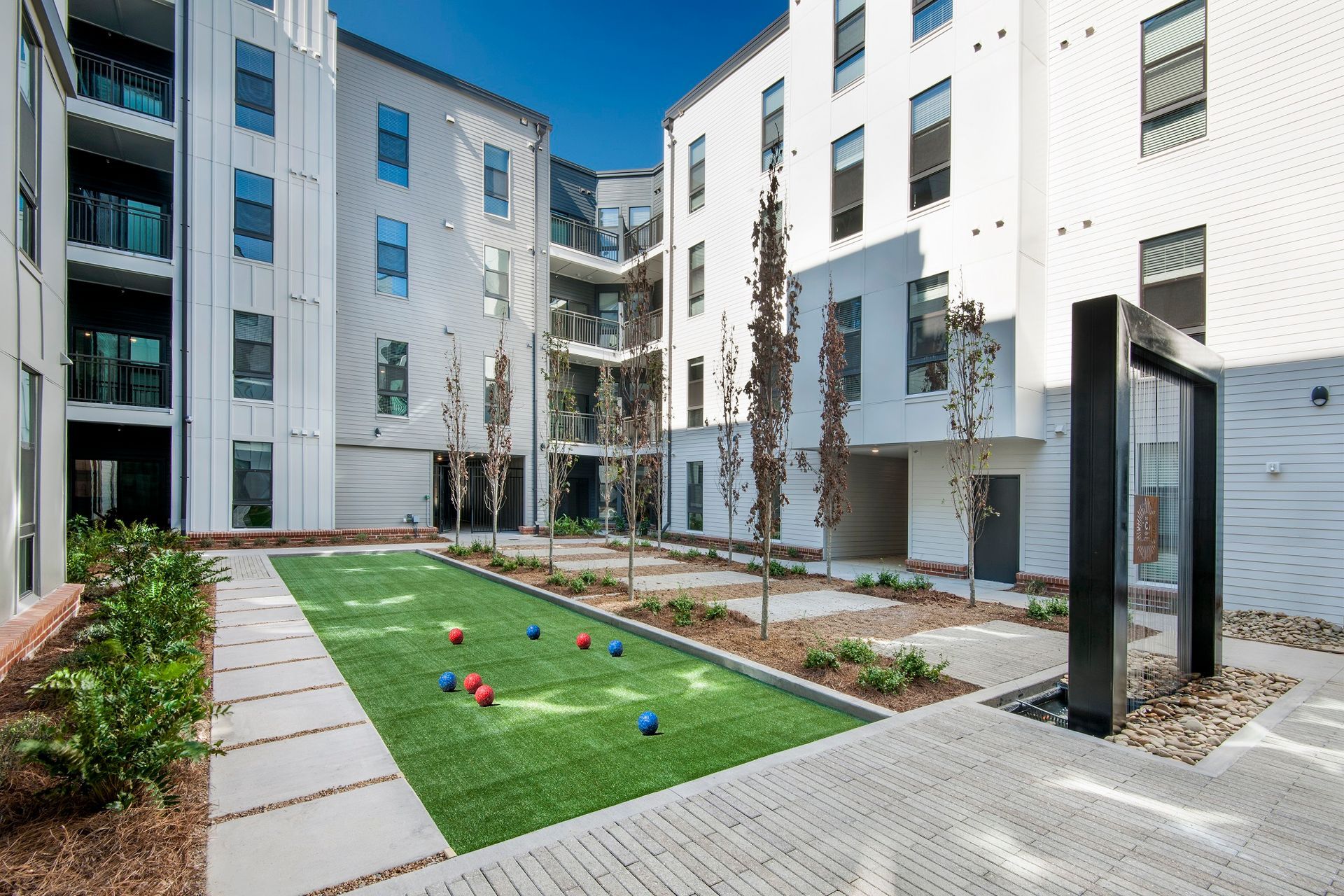 A courtyard with a bowling alley in the middle of a building.