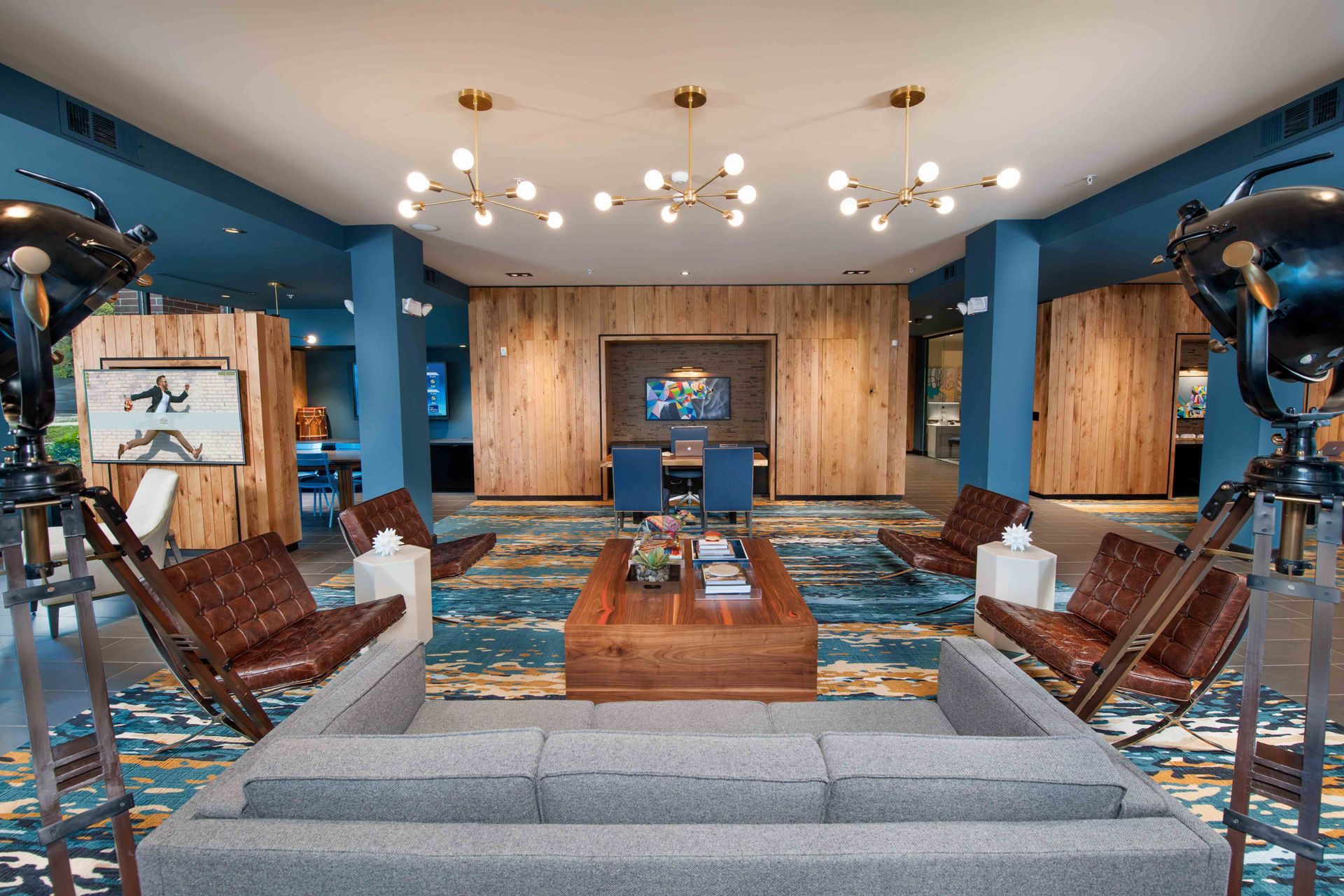 A room with a couch, chairs, and a coffee table.