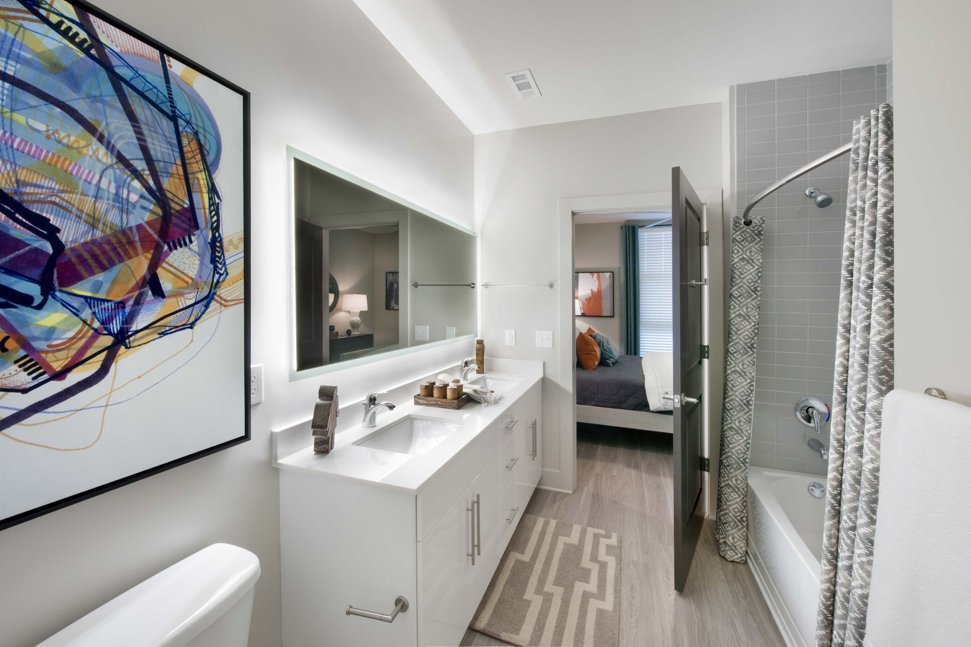 A bathroom with two sinks, a toilet, and a bathtub.