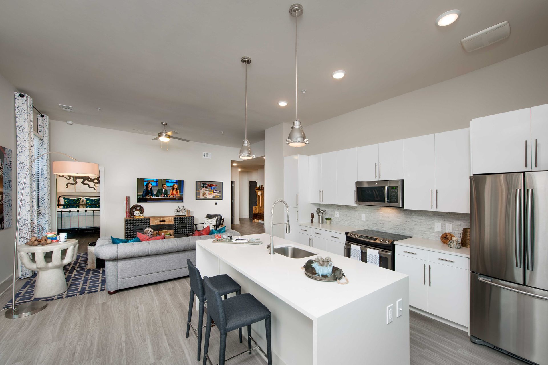 A kitchen with white cabinets and stainless steel appliances.