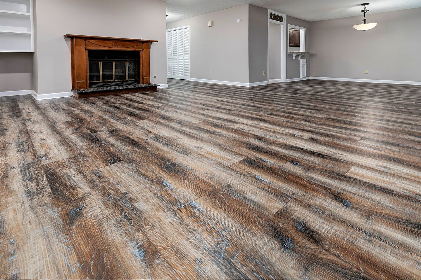 A living room with hardwood floors and a fireplace.