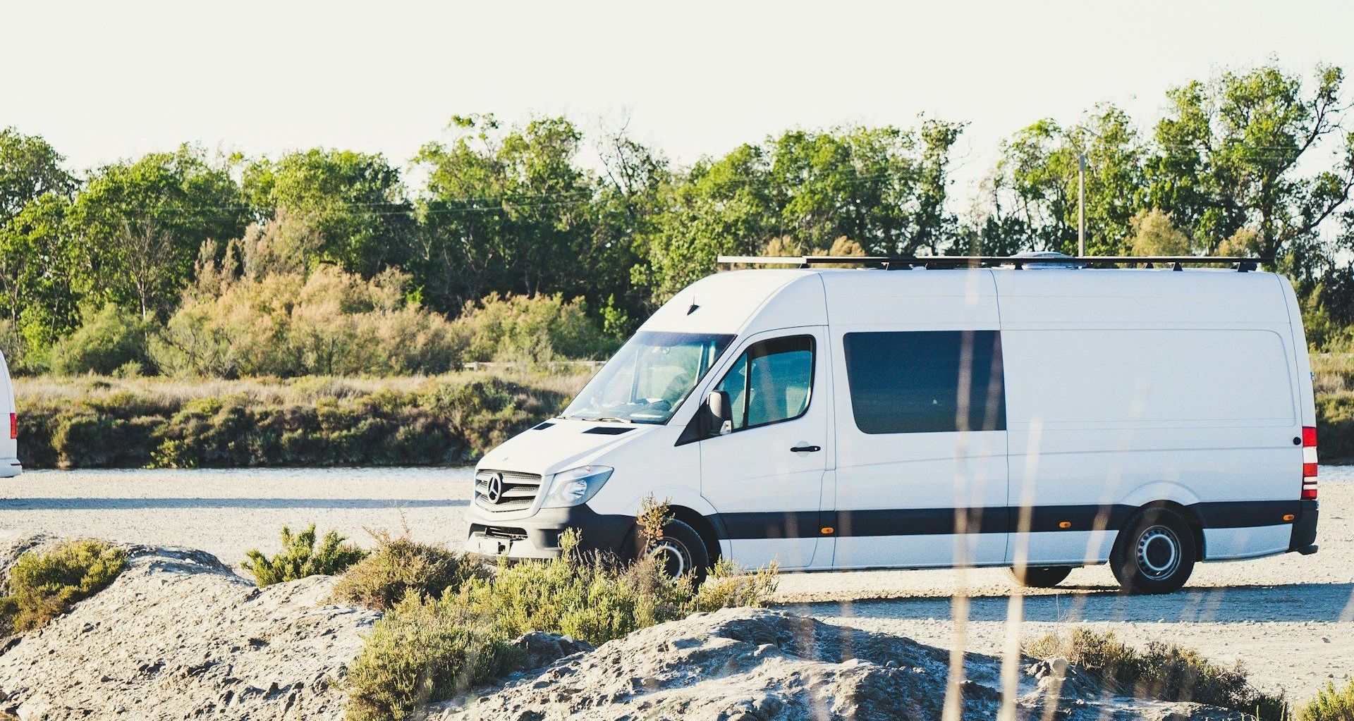 A white van is parked on the side of the road.