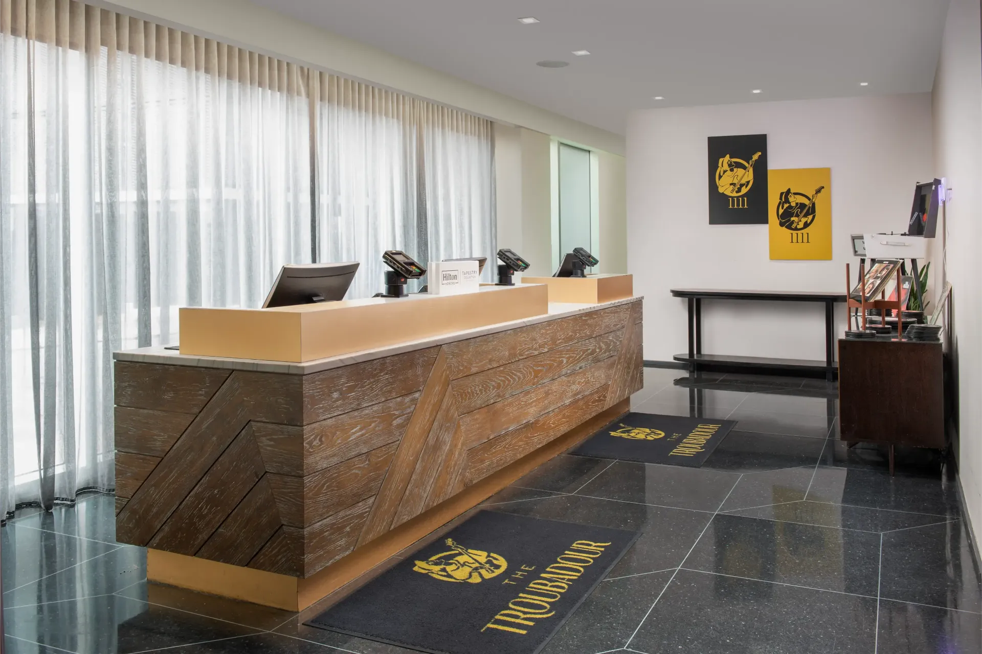 A hotel lobby with a long wooden reception desk