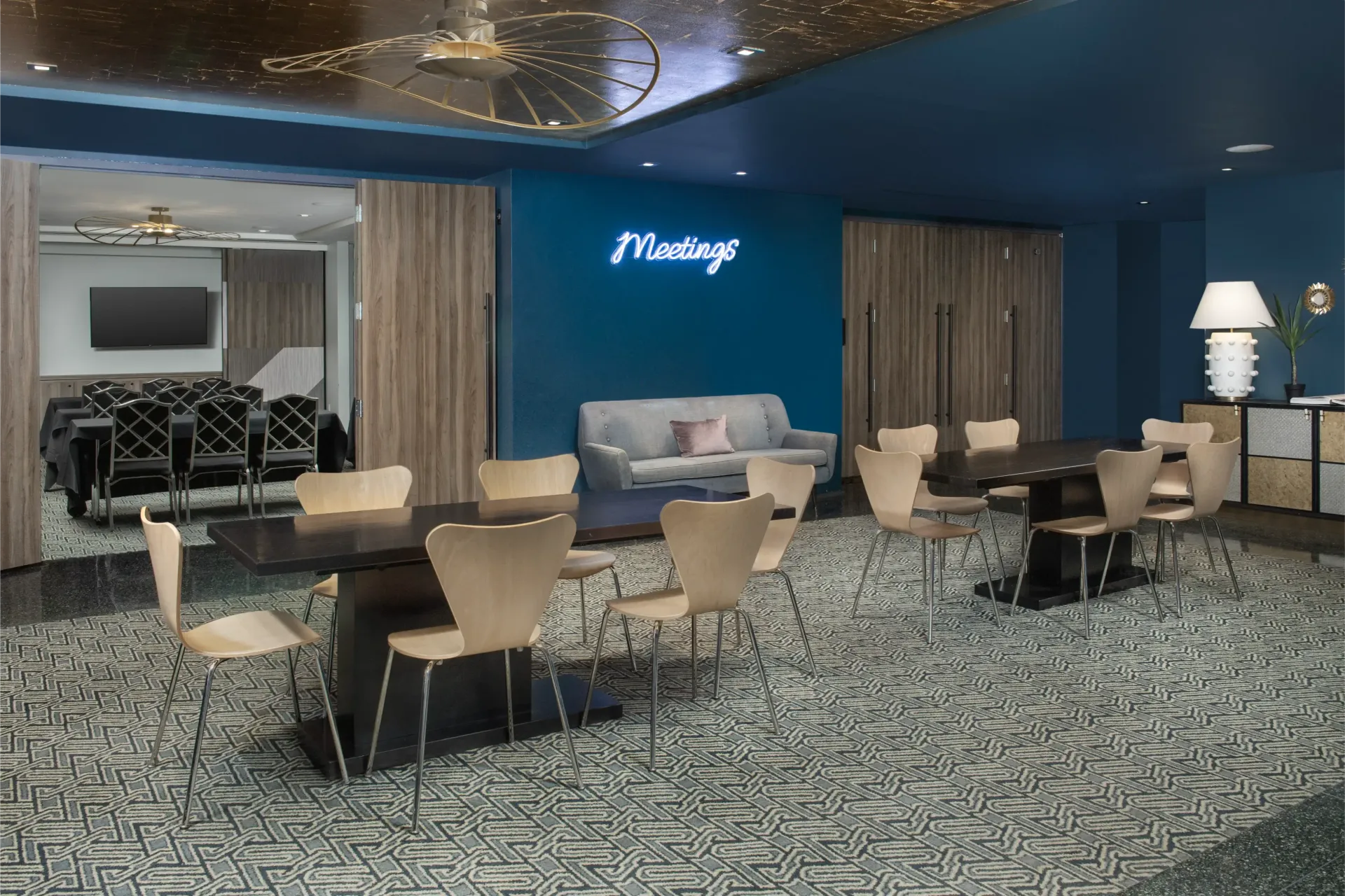 A room with tables and chairs and a couch in it