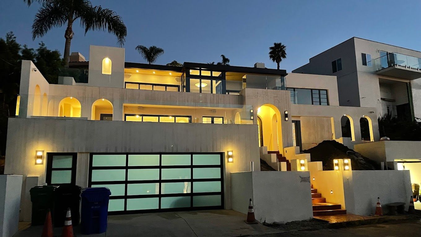 A large white house is lit up at night