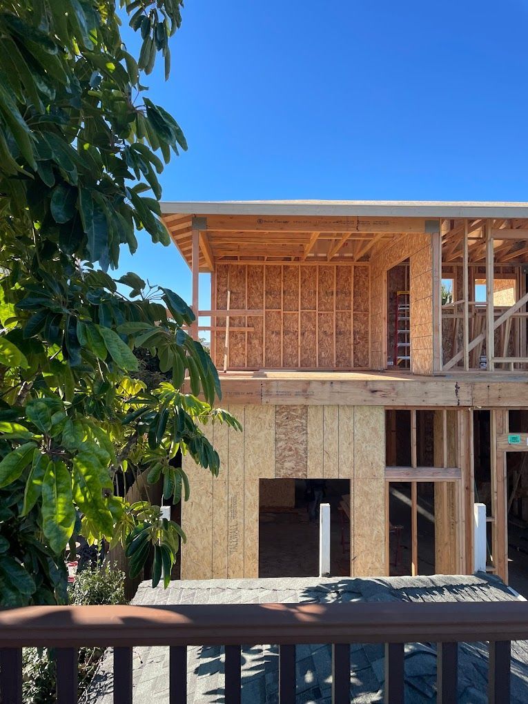 A house is being built with a blue sky in the background.
