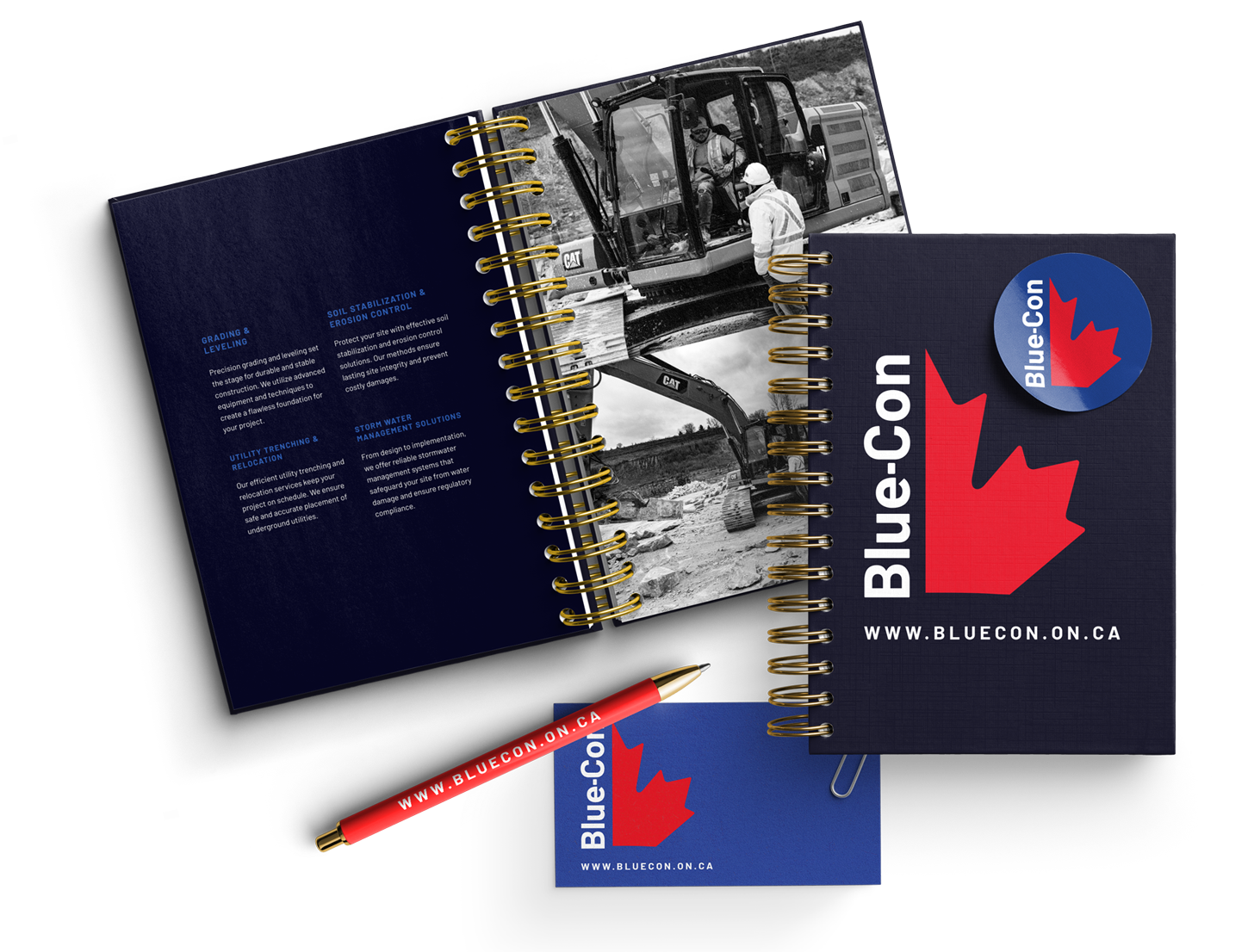 A blue con notebook with a pen and stickers