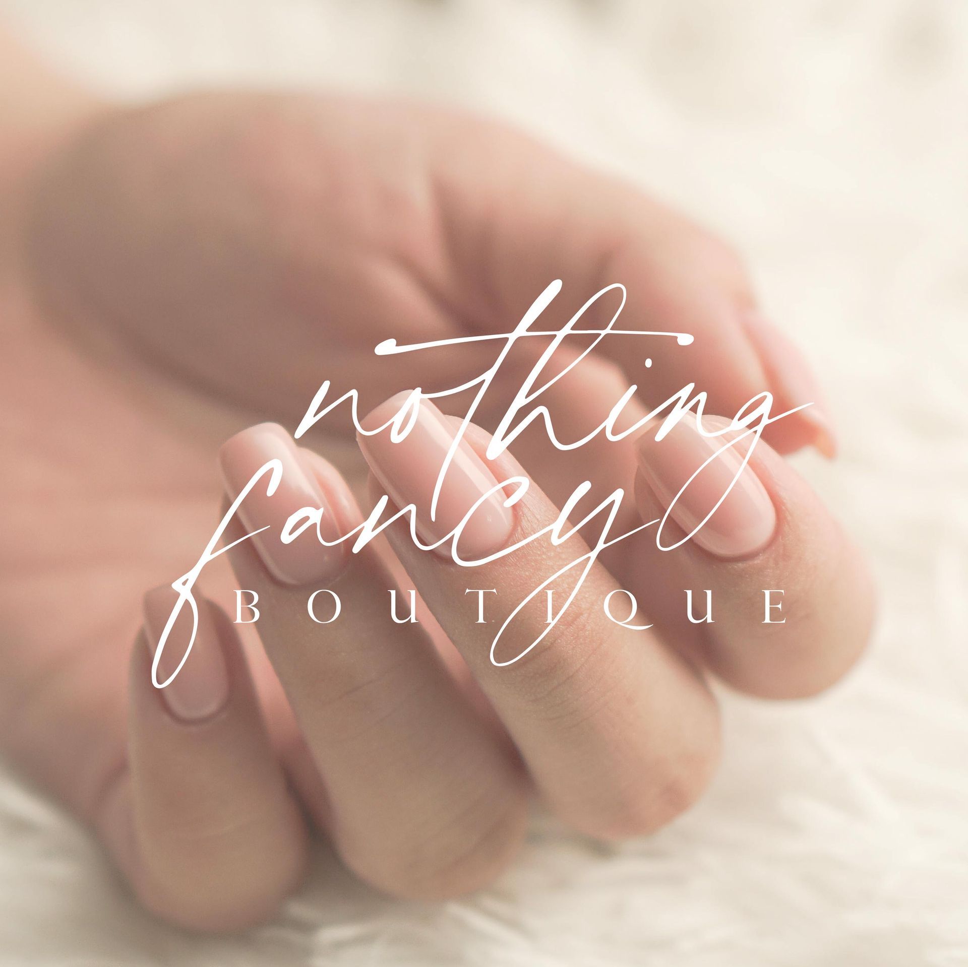 A woman 's hands are holding a logo for nothing fancy boutique
