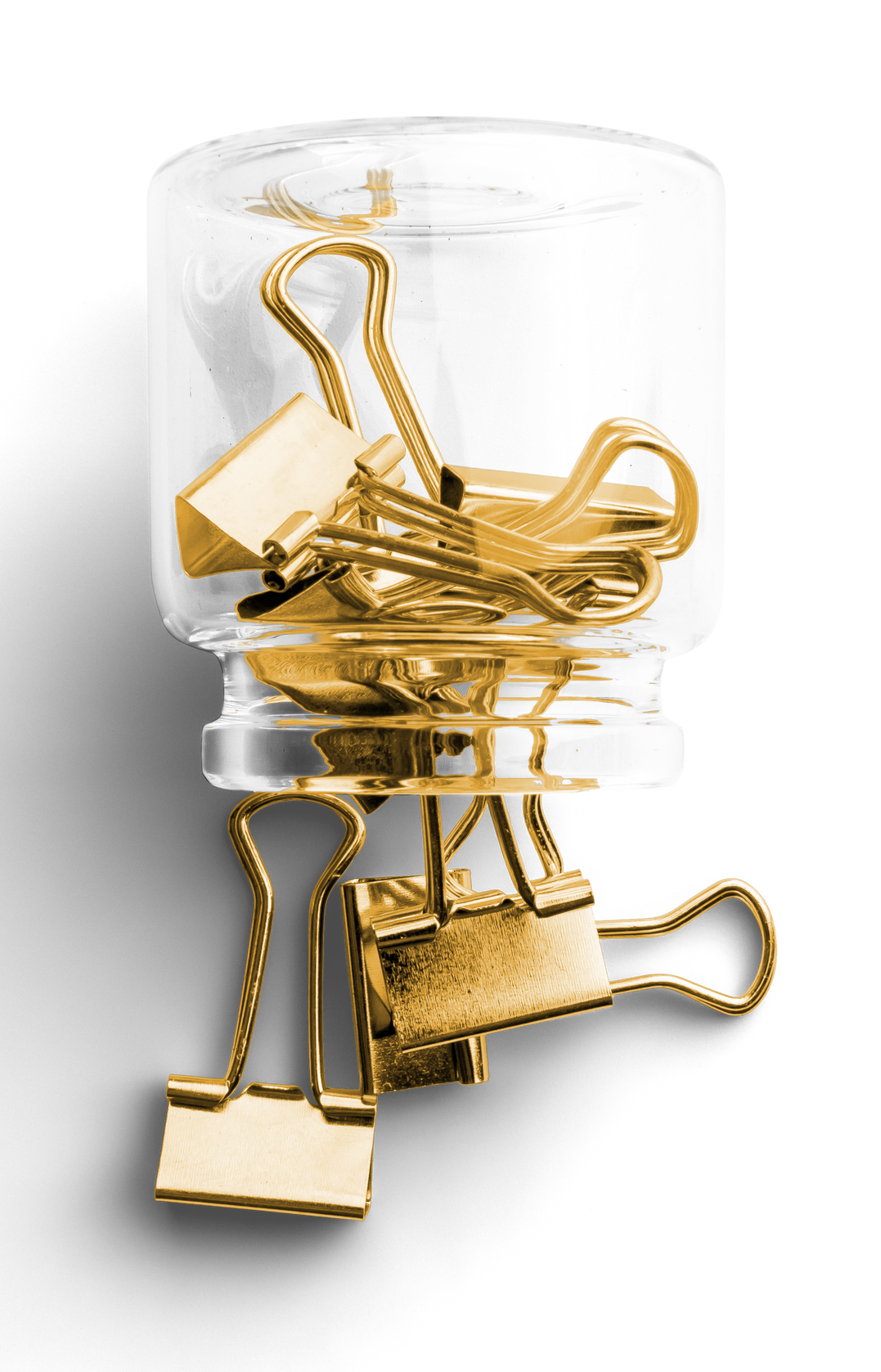 A glass jar filled with gold paper clips on a white background.