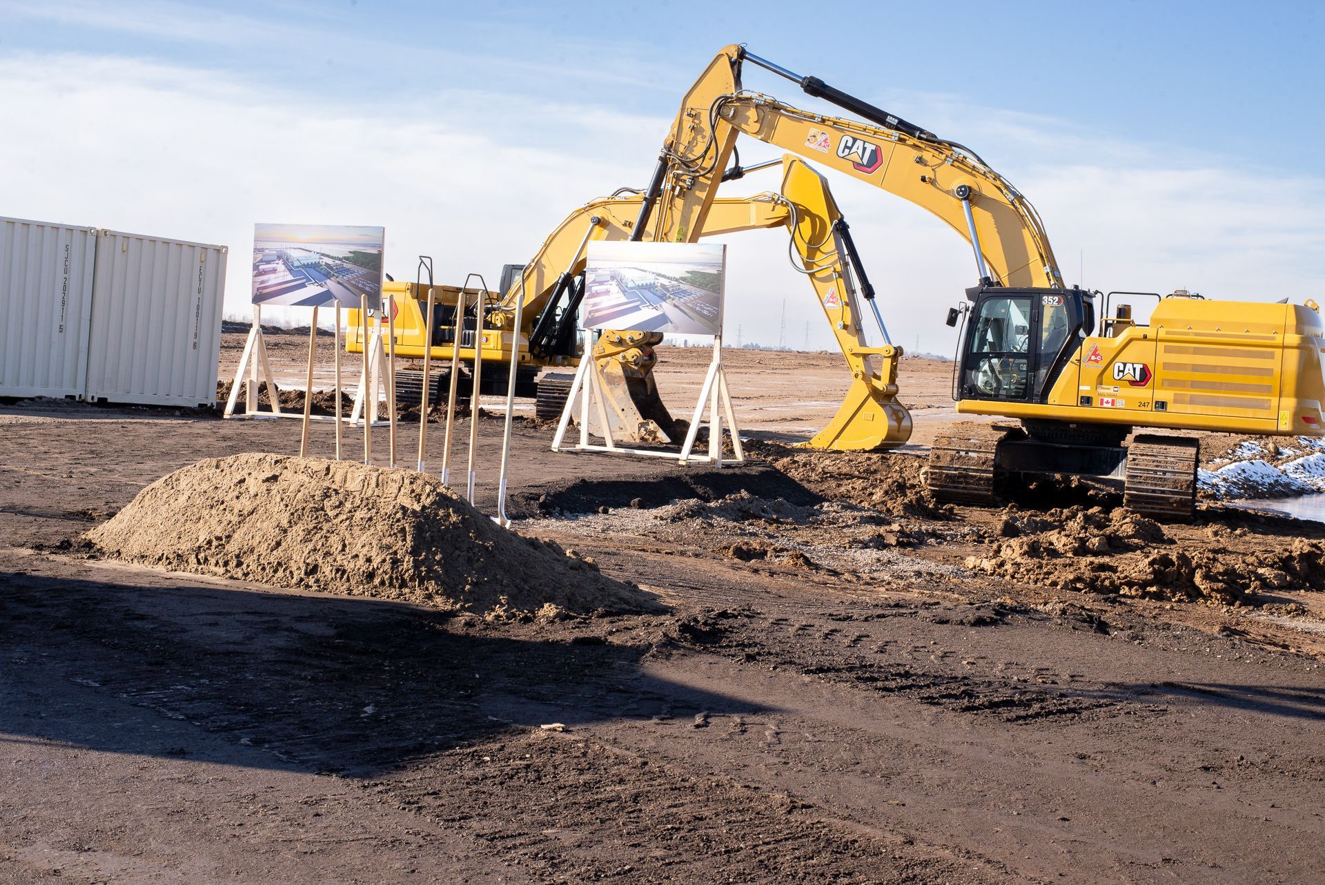 Silver laptop on a white surface, screen off, angled open.