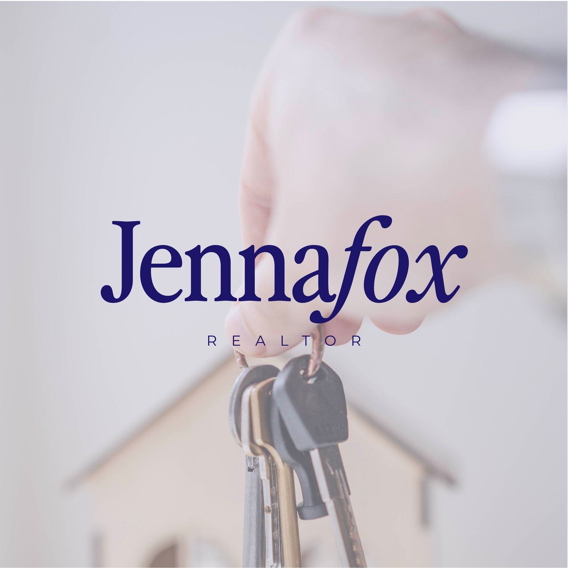 A person is holding a bunch of keys in front of a model house.
