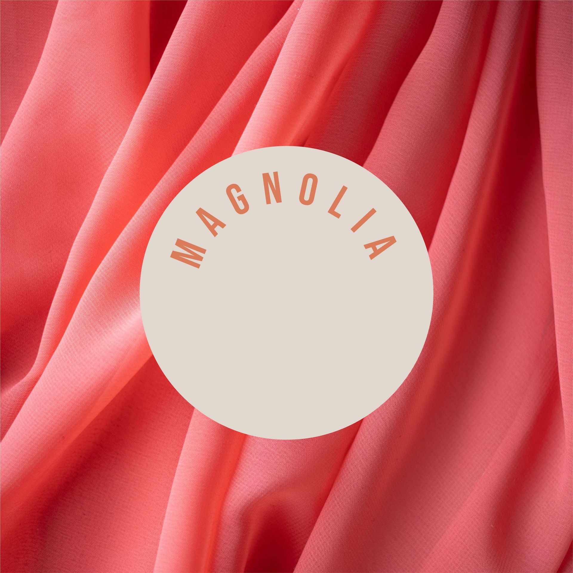A pink cloth with a white circle that says magnolia
