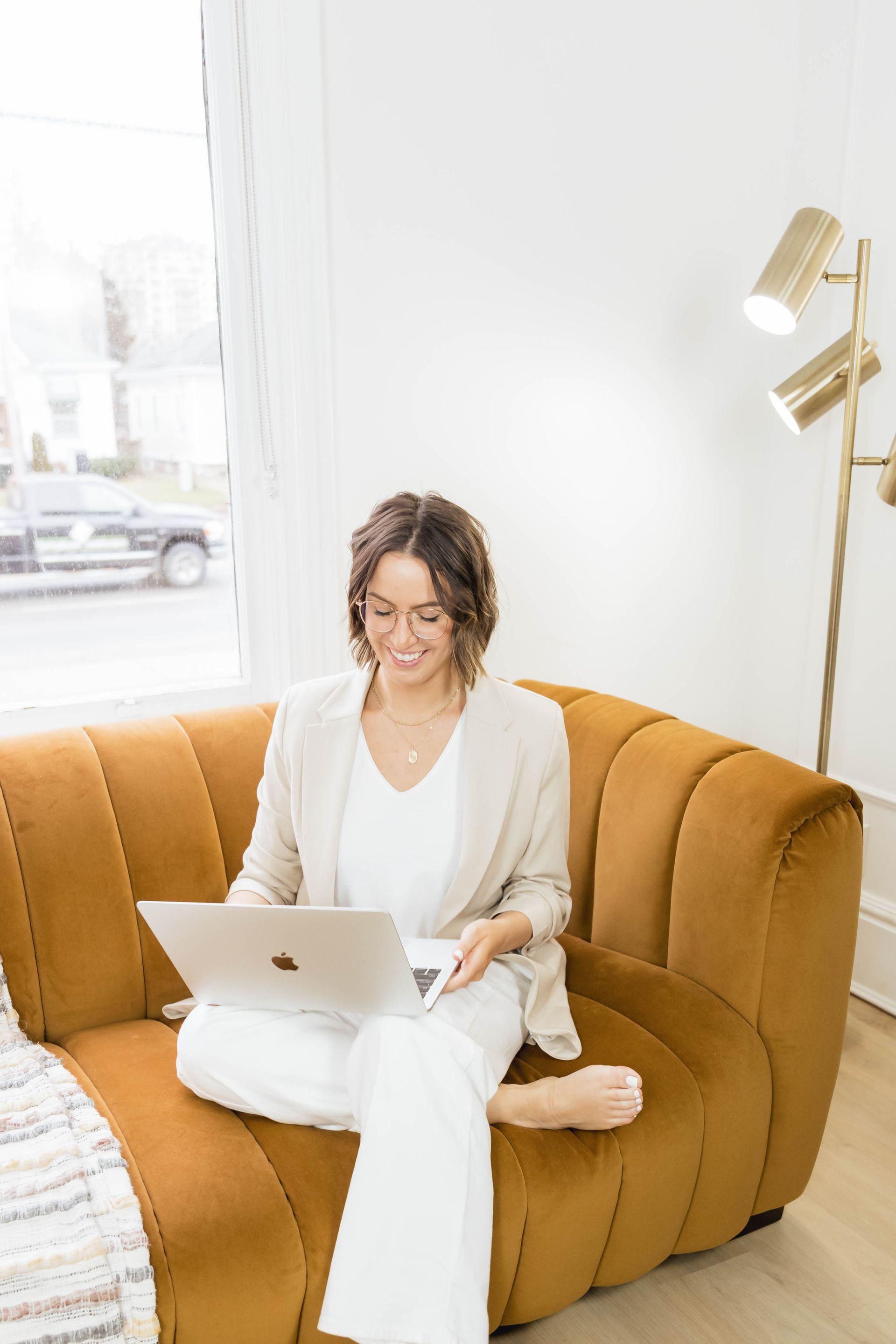 Woman reviewing business website on a laptop wondering if her outdated site is costing her clients