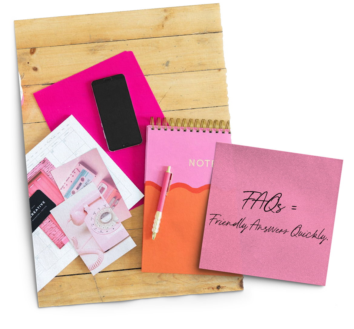 A wooden table topped with pink notebooks and a cell phone