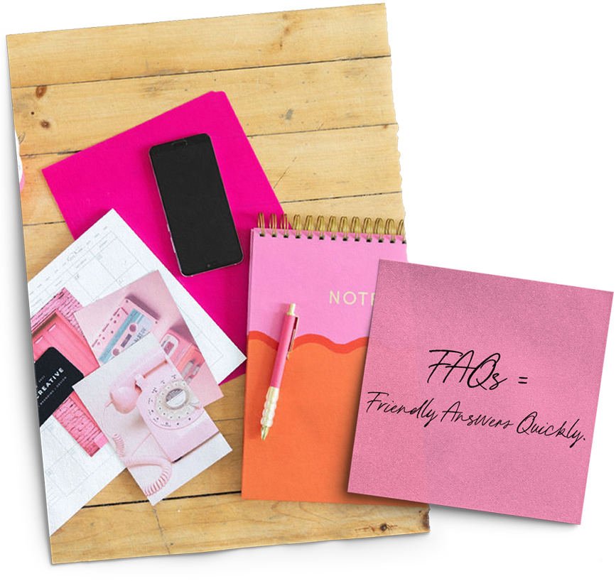 A wooden table topped with pink notebooks and a cell phone