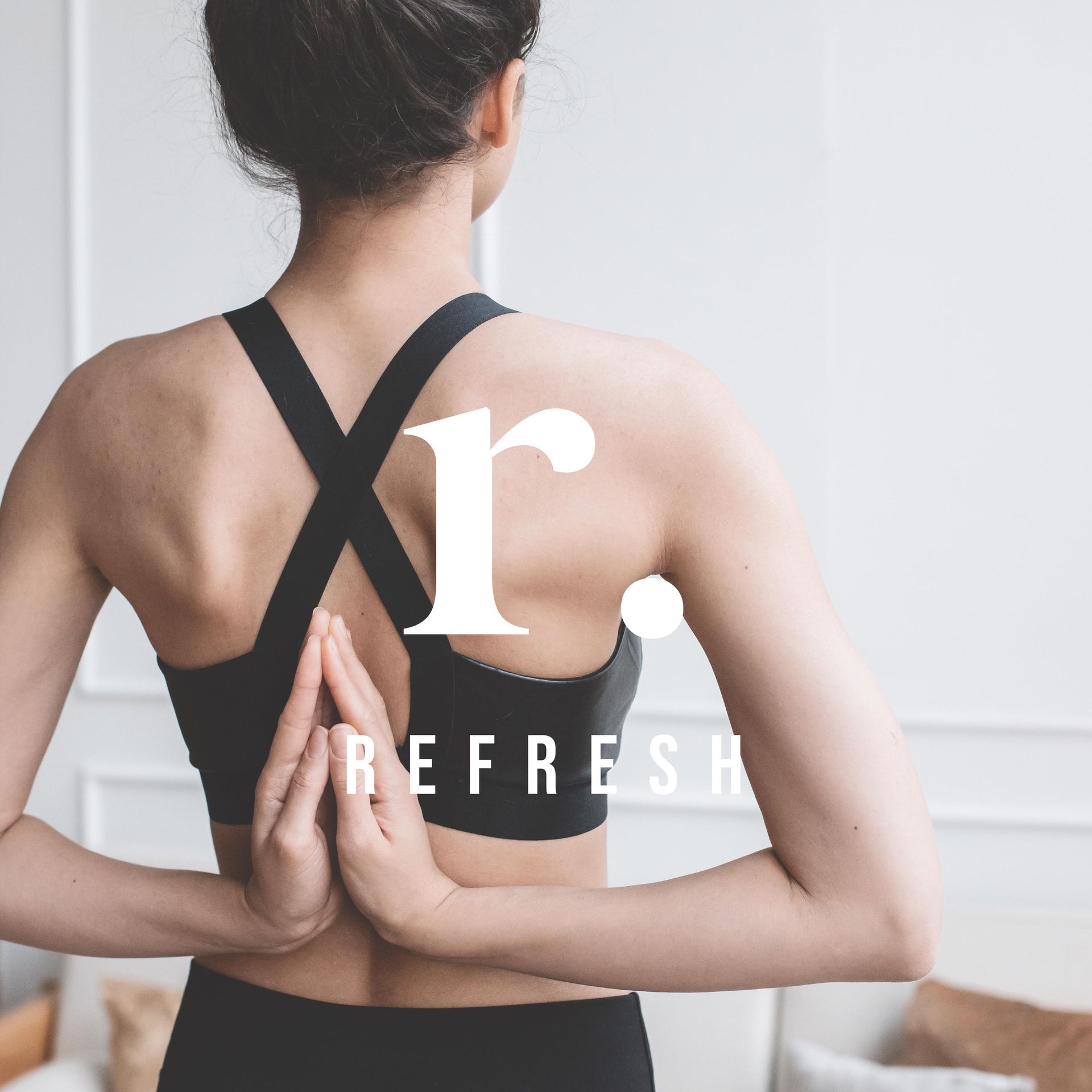 A woman in a black sports bra with the letter r on her back