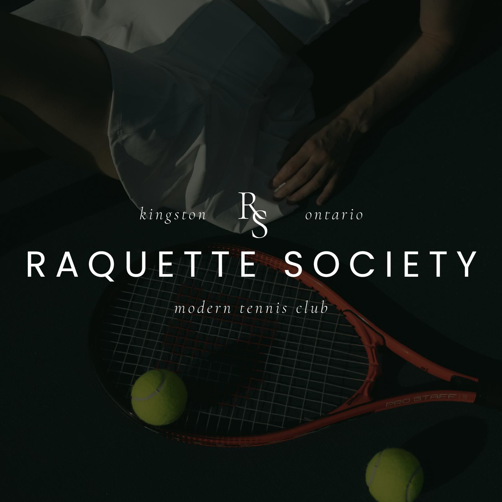 A person is holding a racquet with the words raquette society on it