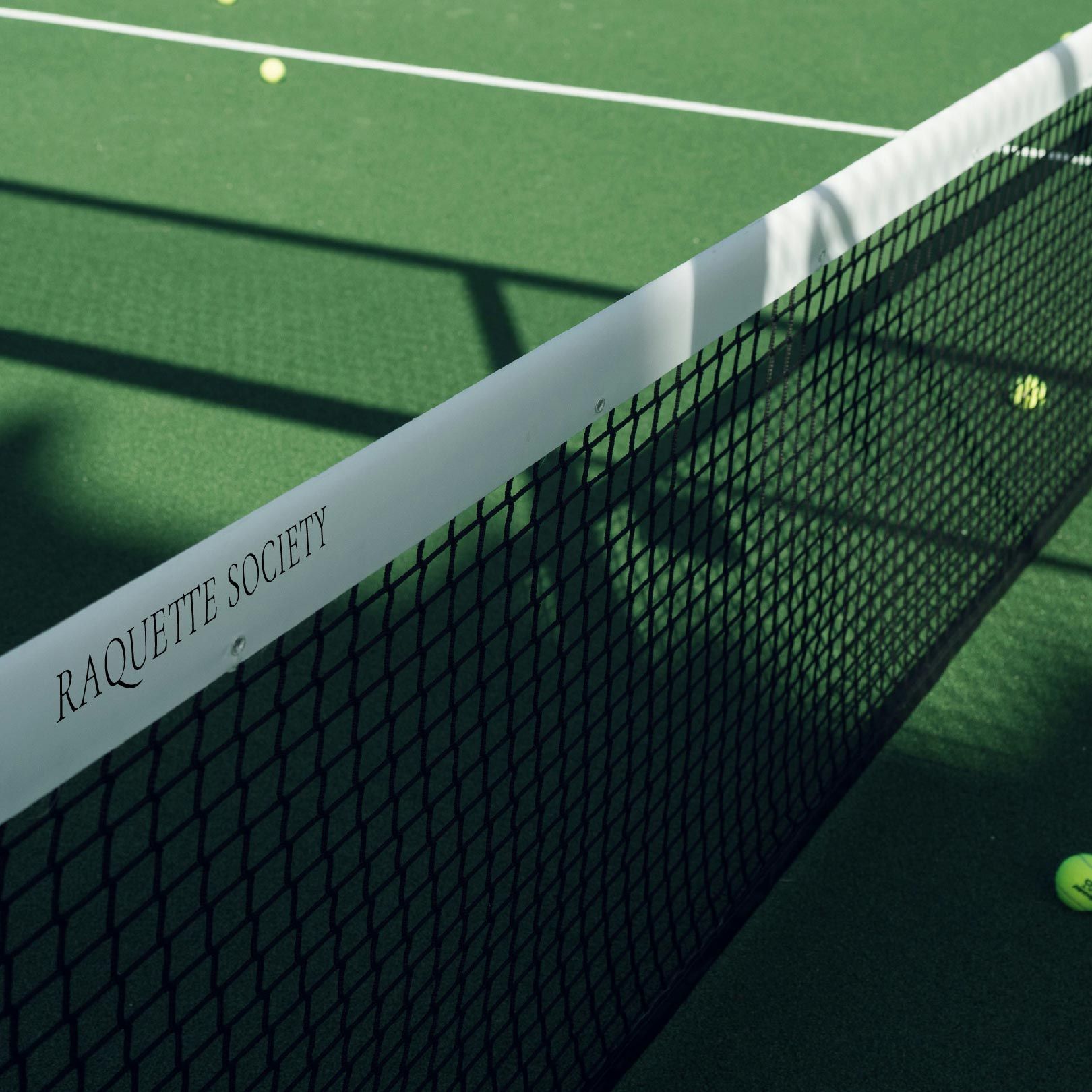 A tennis net that says racquet society on it