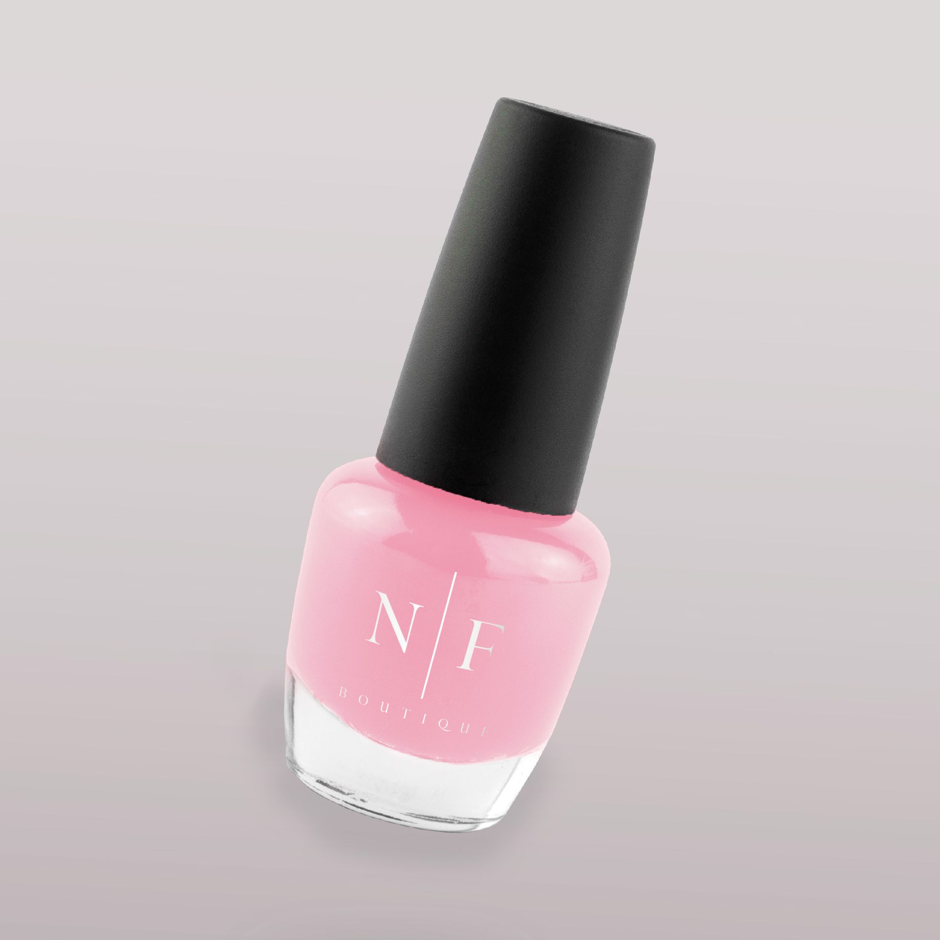 A bottle of pink nail polish with the letter n on it