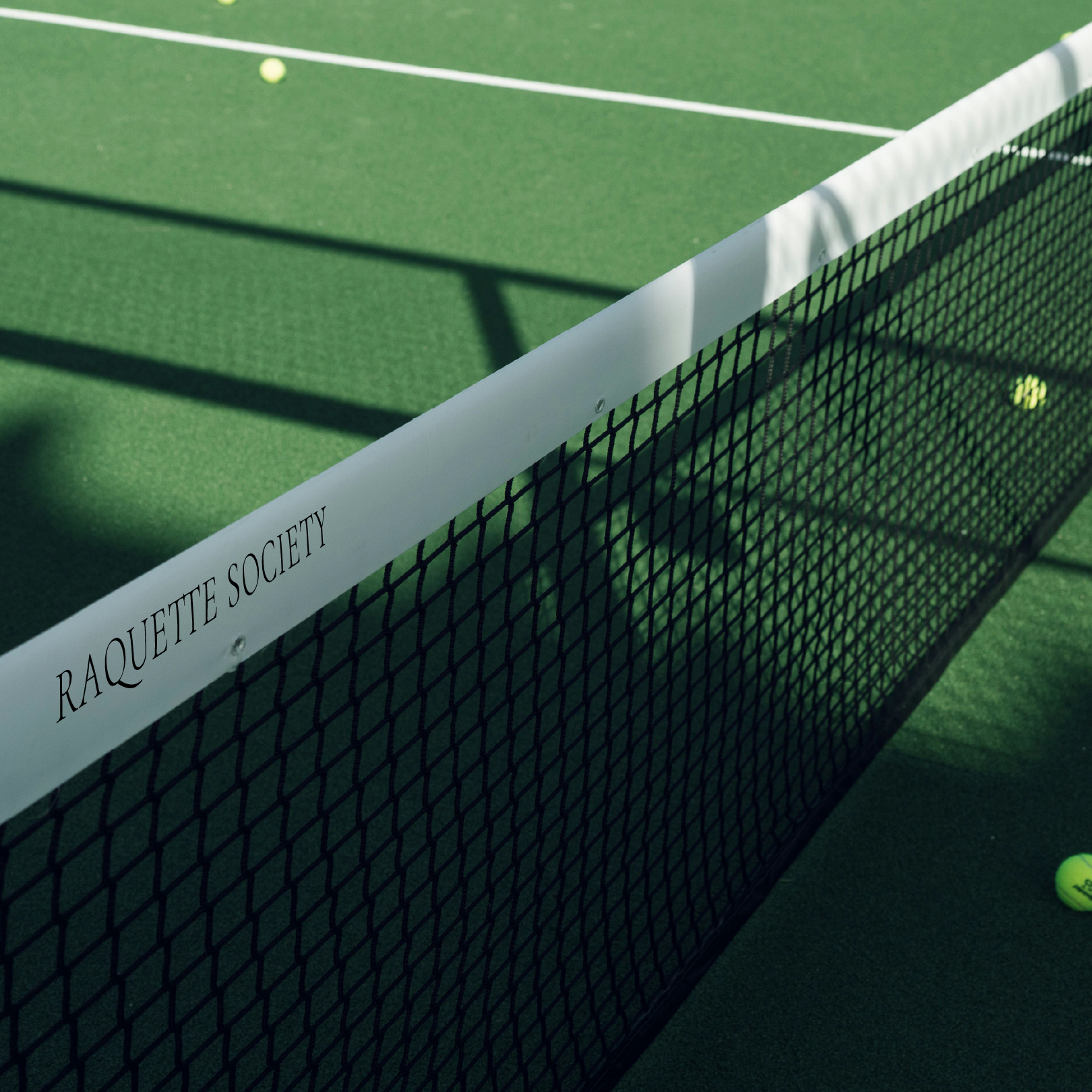 A tennis net that says racquet society on it