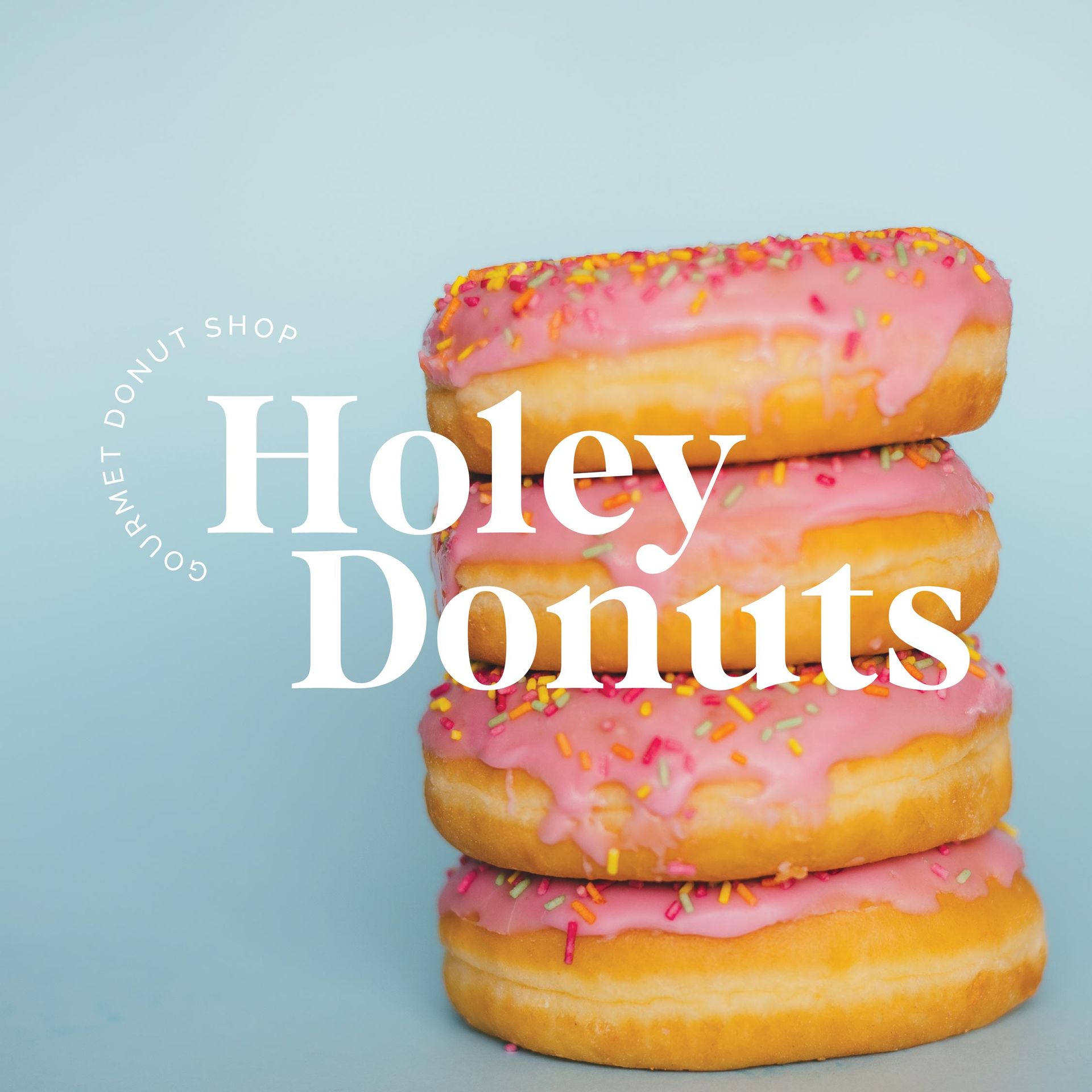 Three donuts with pink frosting and sprinkles are stacked on top of each other ..