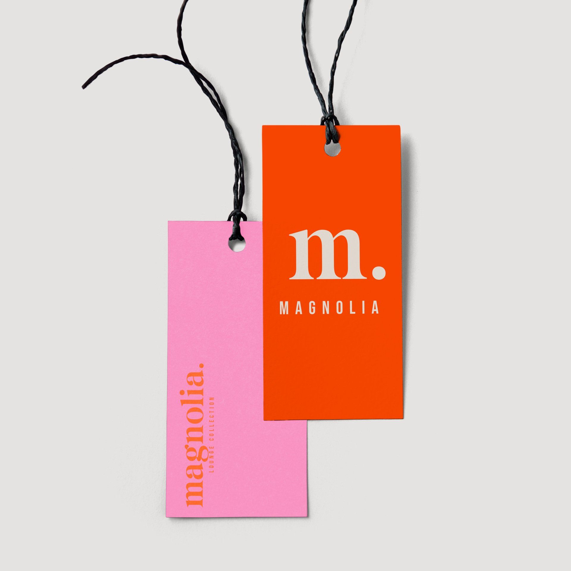 A pink and orange tag that says magnolia on it