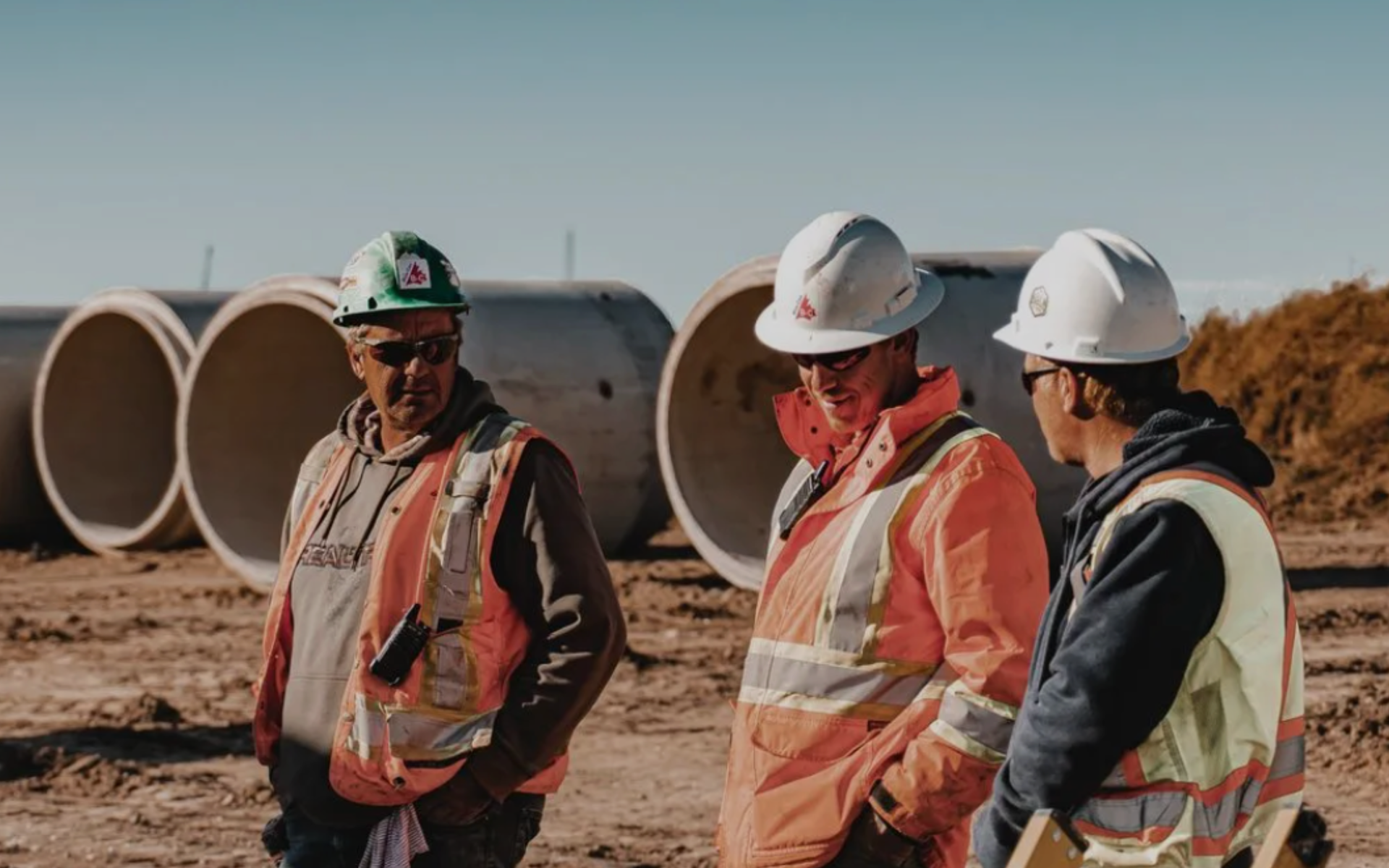 Silver laptop on a white surface, screen off, angled open.