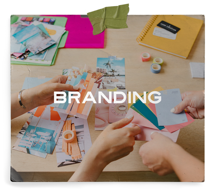 A group of people are sitting at a table working on a branding project.