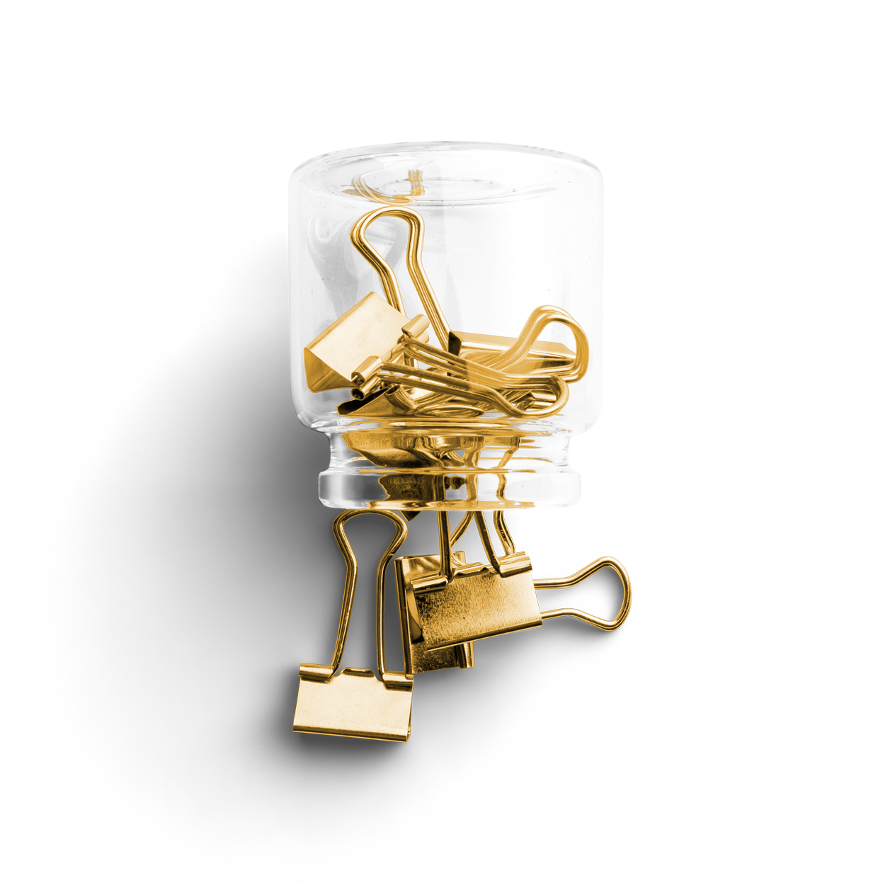 A glass jar filled with gold paper clips on a white background.