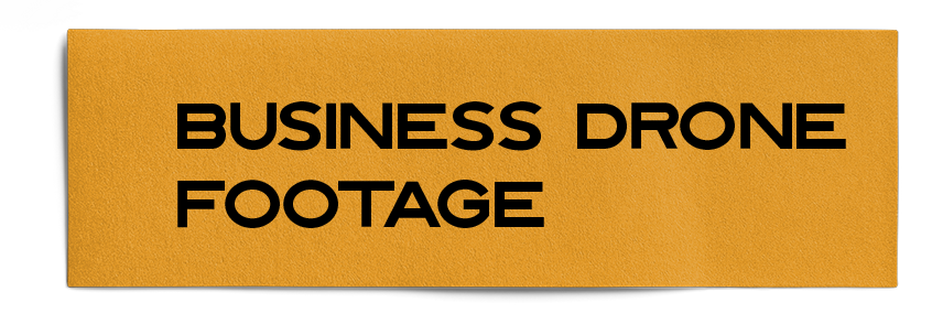 A yellow sign that says business drone footage