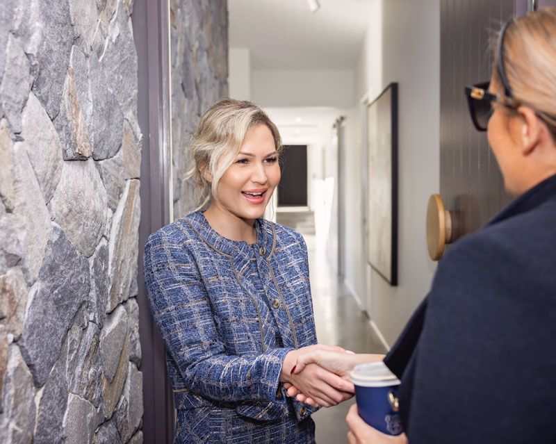 Nicole shaking a clients had