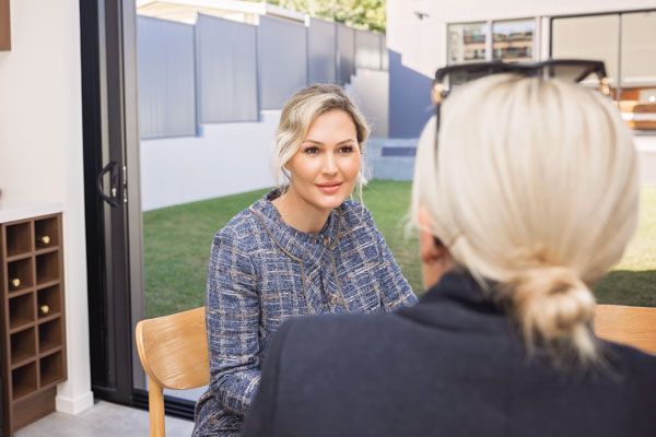 Nicole speaking with a client