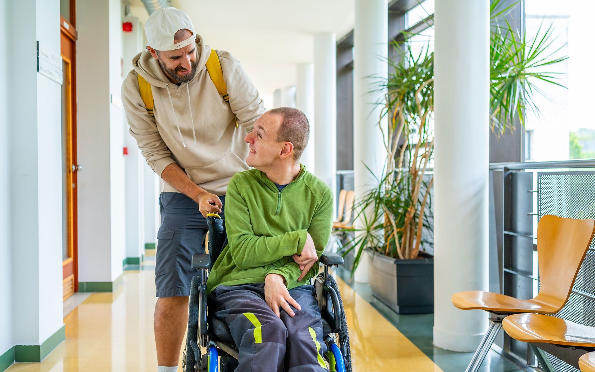 Man and a person with disability around the university