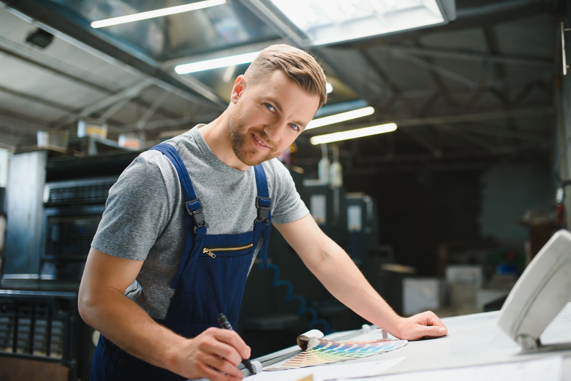 A designer looking through colour swatches in a printing manufacturers.