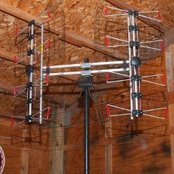 A large antenna is hanging in the attic.