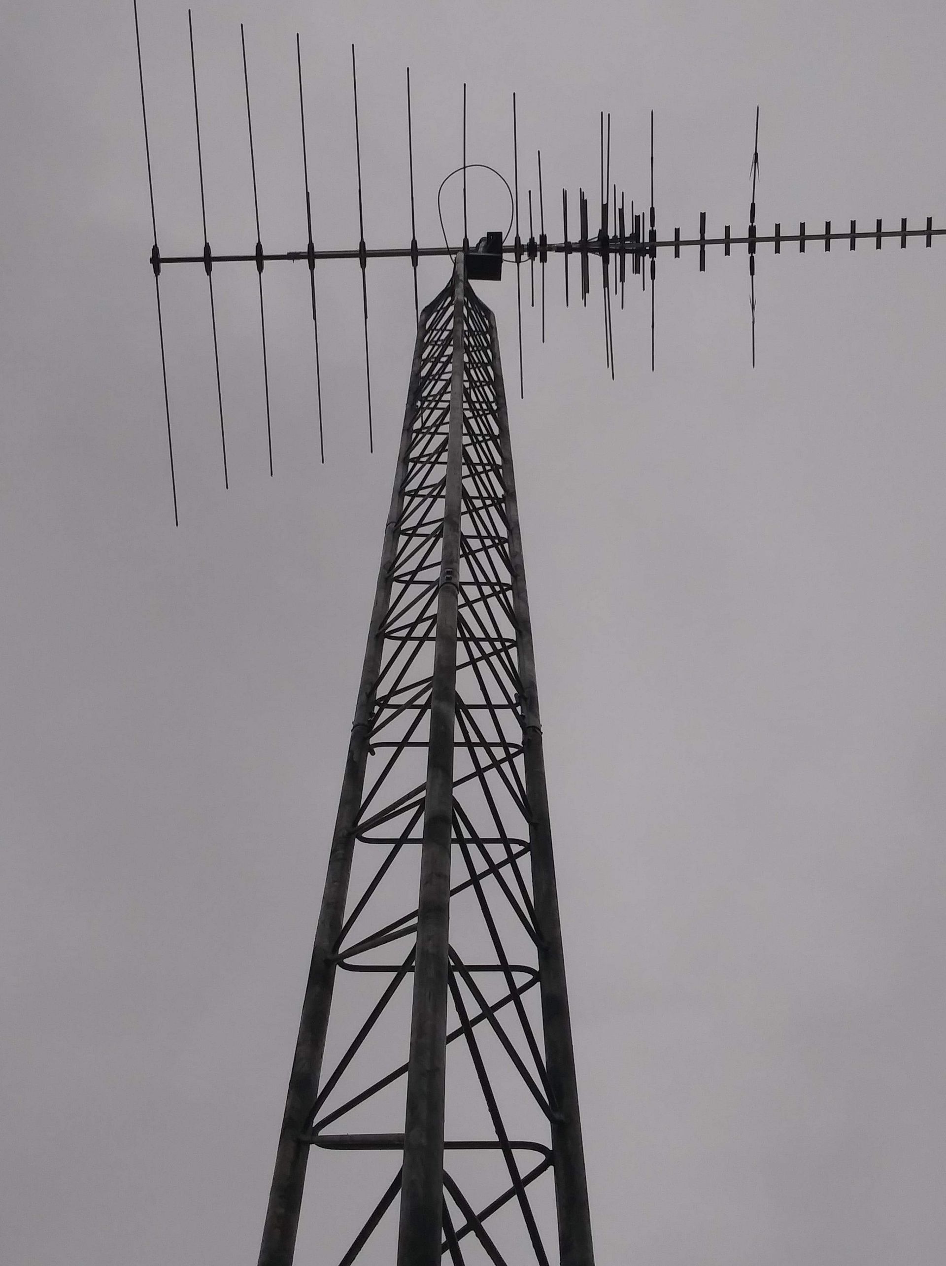 A black and white photo of a tower in the water