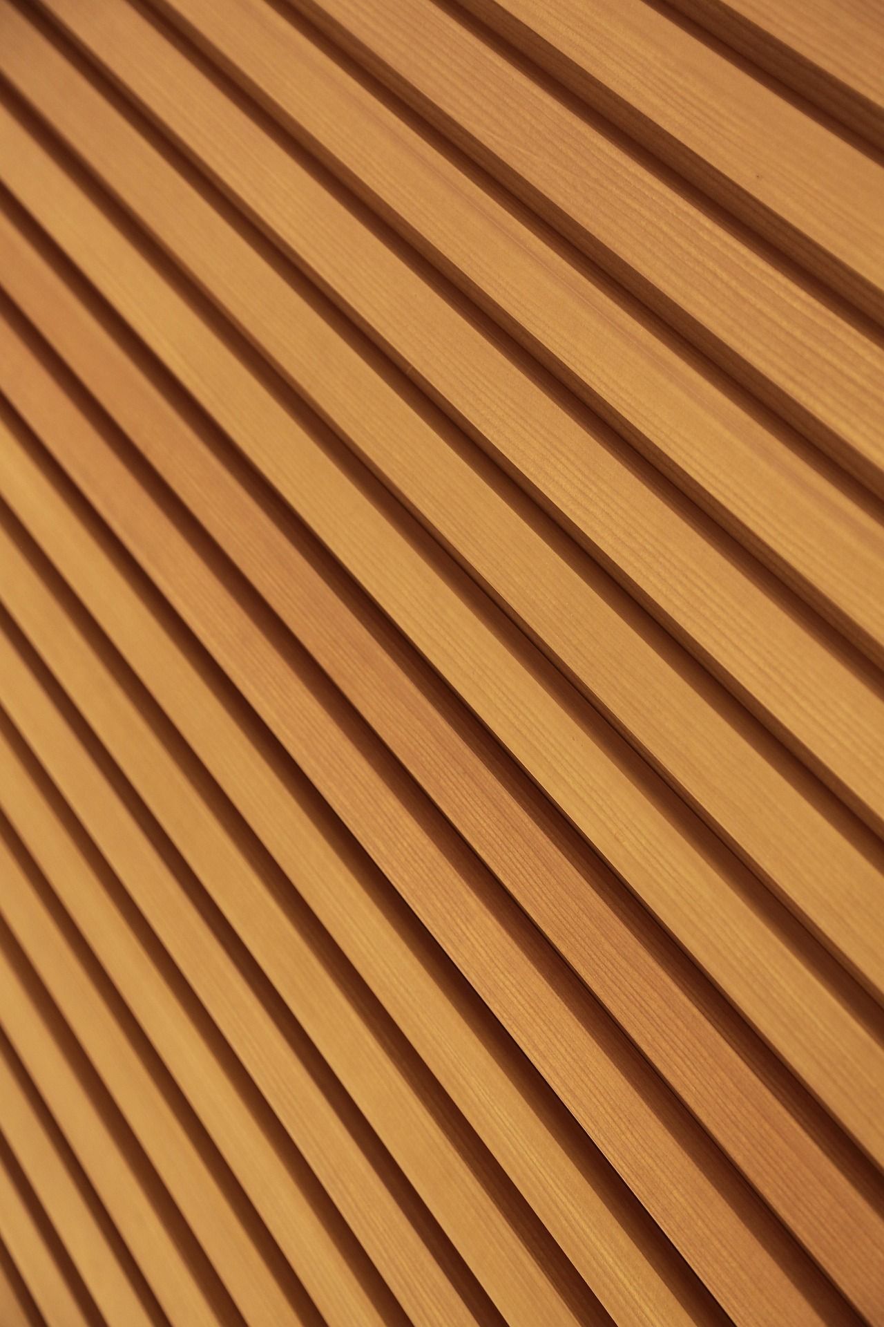 Diagonal wooden slats in warm brown tones creating a striped textured pattern