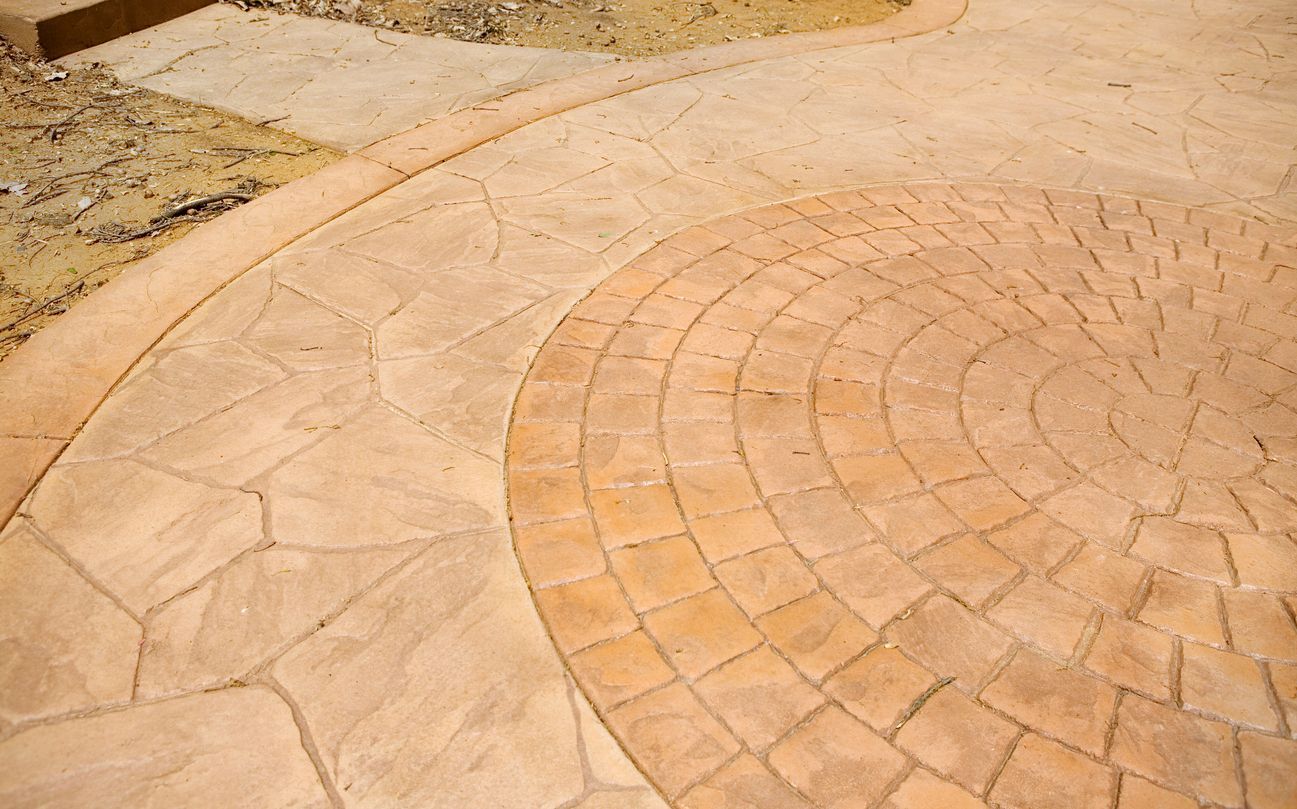 A concrete walkway with a circular pattern on it