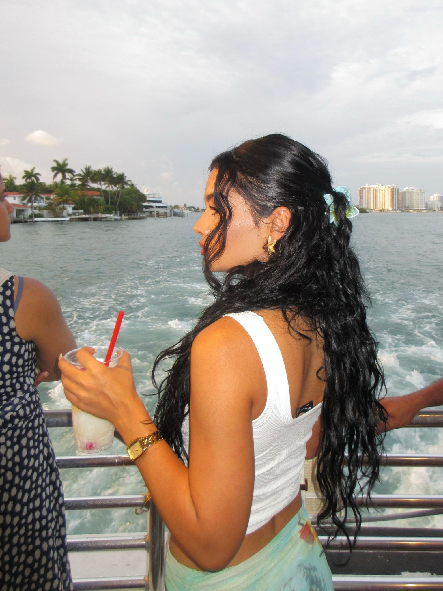 Woman admiring celebrity homes during a Miami sightseeing boat tour discount cruise
