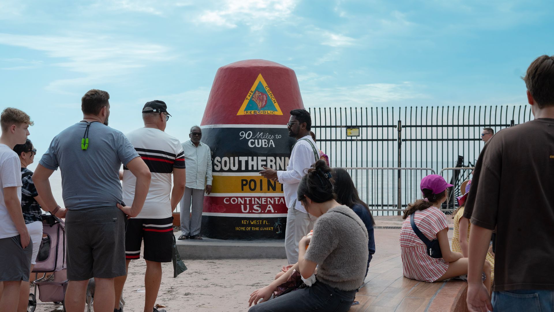 Passengers from Miami to Key West in the Southernmost Point in Key West talking photos